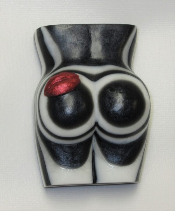 A black and white ceramic sculpture of a woman 's butt.