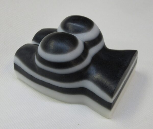 A black and white soap sitting on top of a counter.