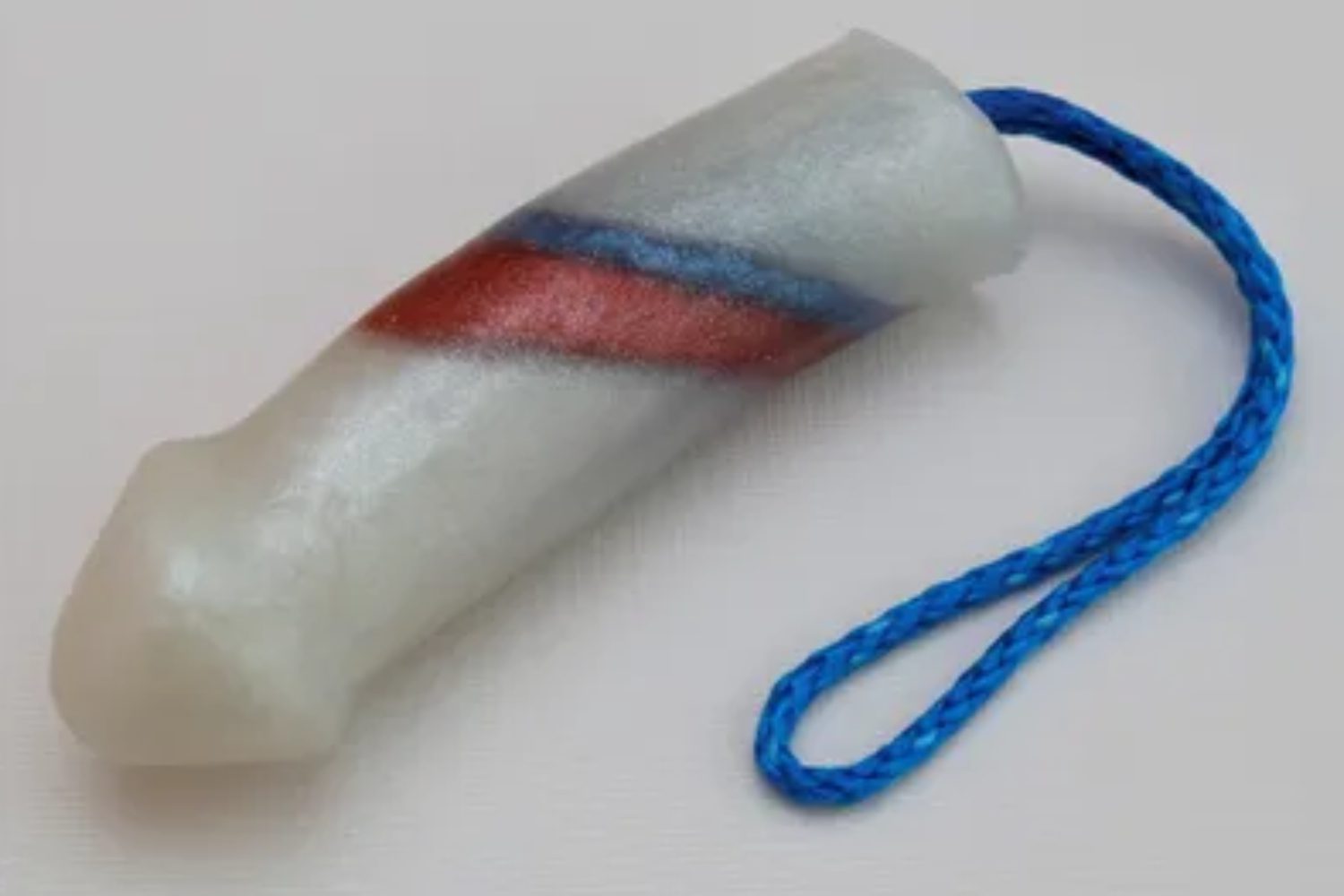 A plastic tube with a blue string attached to it.