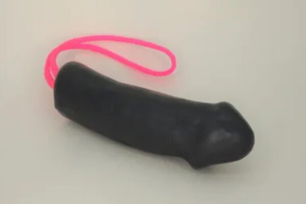 A black dildo with pink string on it.