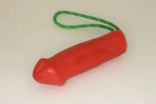 A red toy with green string hanging from it.