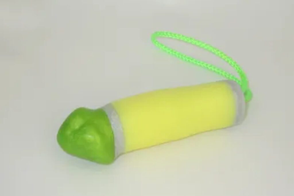 A yellow and green toy with a string.