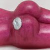 A purple potato with a white dot on it's stomach.