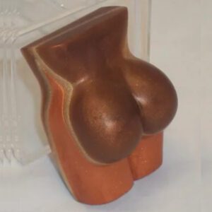 A wooden sculpture of a woman 's boobs.