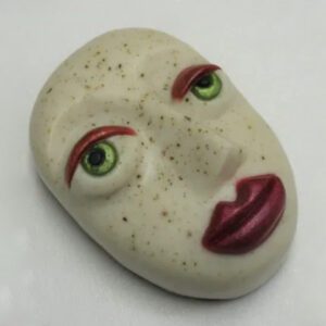 A white face with red lips and green eyes.