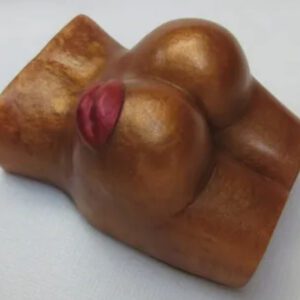 A wooden toy of a woman 's breast and buttocks.