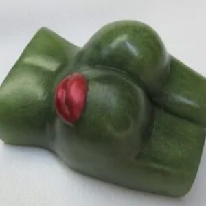 A green piece of food with red lipstick on it.