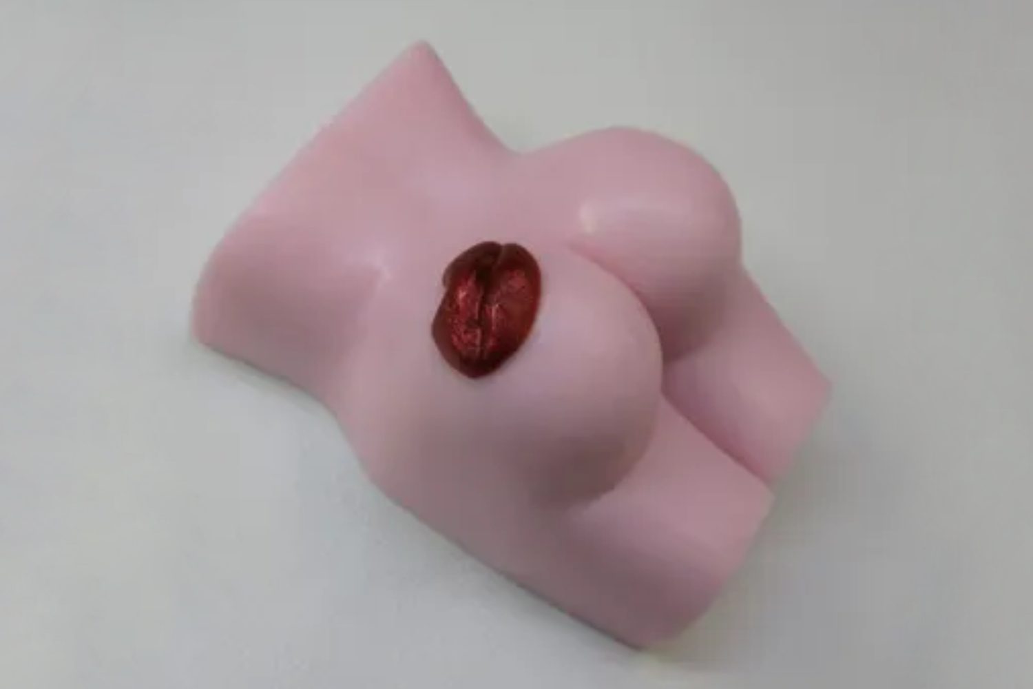 A pink toy shaped like a woman 's breast.