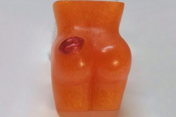 A soap shaped like an orange woman 's butt.