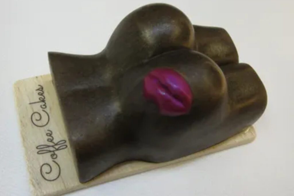 A chocolate hand with a pink lip mark