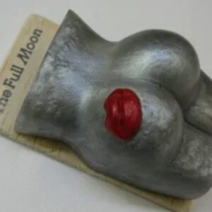 A metal object with red nose and nipple.