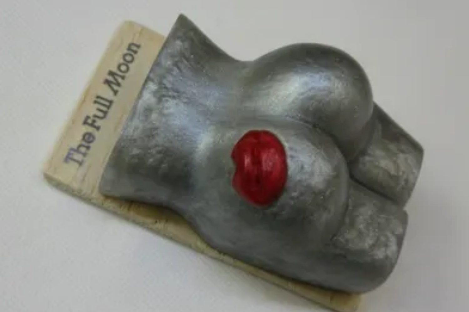 A metal object with red nose and nipple.