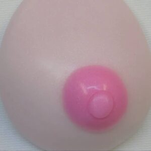 A pink breast implant is shown on the side of a wall.