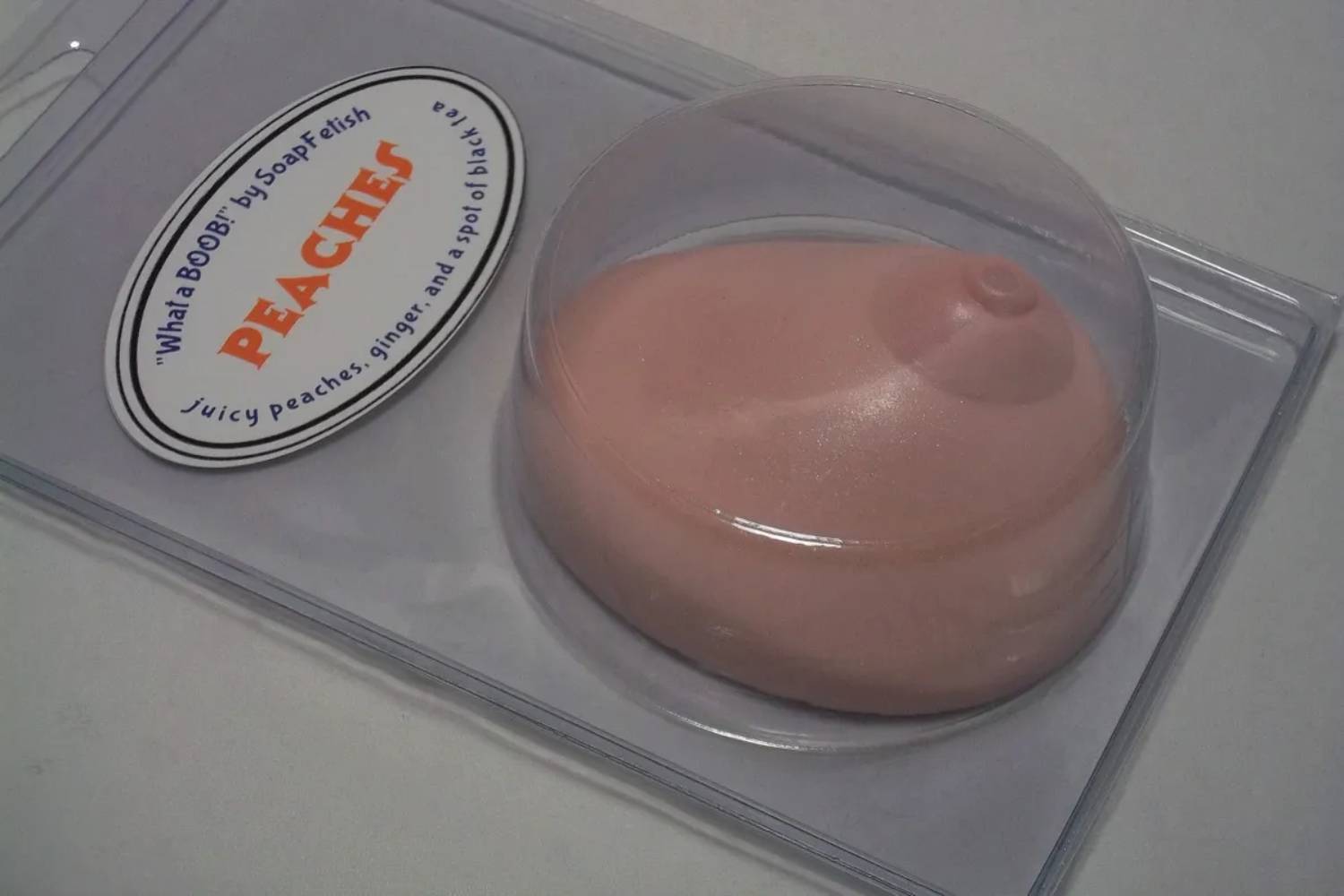 A pink soap sitting on top of a plastic container.