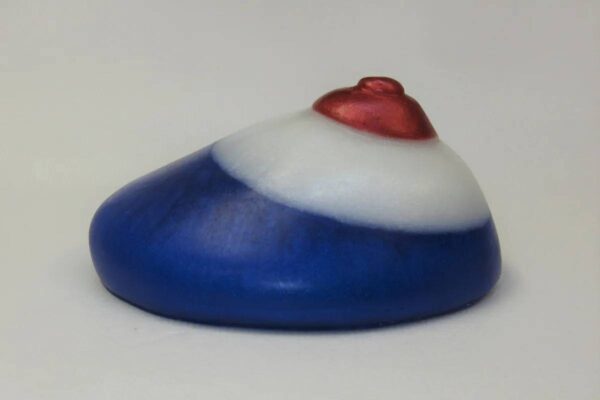 A blue and white rock with red heart on top.