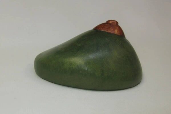 A green object with a red face on it.