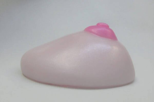 A pink condom sitting on top of a table.