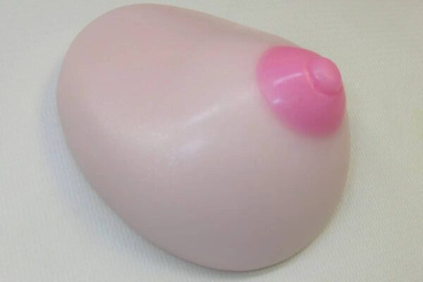 A pink ball with a small pink heart on it.