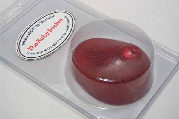 A red cake in a plastic container with the label