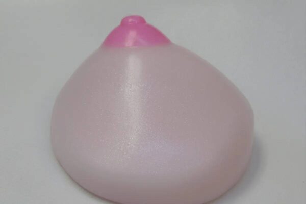 A pink condom sitting on top of a table.