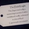 A white tag with the words " the dark knight ".