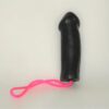 A black toy with pink string on it.