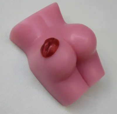 A pink soap shaped like a woman 's boob.