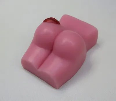 A pink soap shaped like a woman 's butt.
