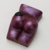 A chocolate piece of art shaped like a woman 's buttocks.