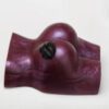 A purple object with two black holes on it.