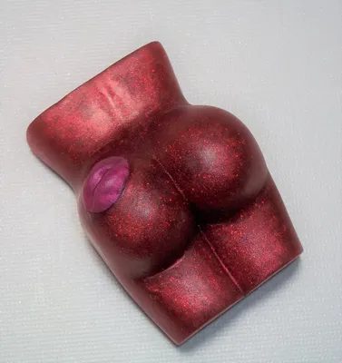 A red toy shaped like a woman 's butt.