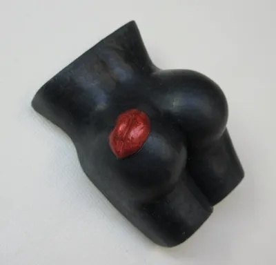 A black rubber toy with red lips on it.