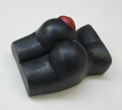 A black rubber toy shaped like a person with red lips.