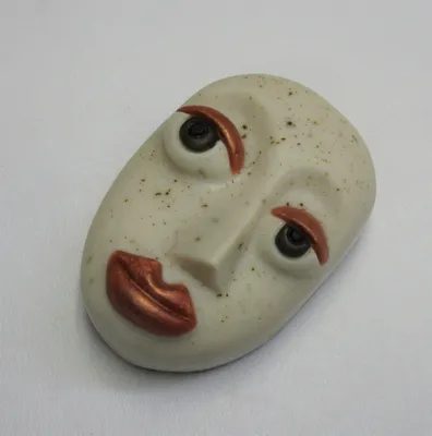 A white face with red lips and green eyes.