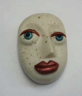 A white face with red lips and blue eyes.