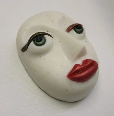 A white face with red lips and brown eyes.