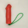 A red condom with green string on it.