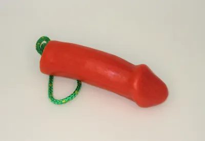 A red toy with green string attached to it.
