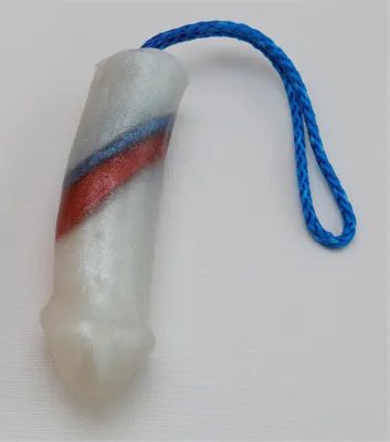 A white plastic tube with red and blue stripes on it.