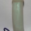 A white candle with purple cord on top of it.