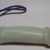 A white plastic tube with purple string attached to it.