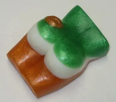 A green and white candy sitting on top of a table.
