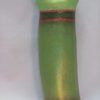 A green object with brown and red stripes on it.
