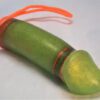 A green toy with orange string on top of it.