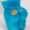 A blue butt toy with a shell on it.