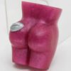 A pink butt shaped object sitting on top of a table.