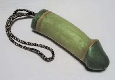 A green and gold tube with chain hanging from it.