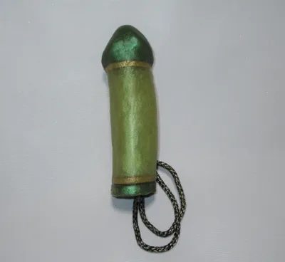 A green condom with a chain around it.