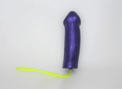 A purple dildo with a yellow string attached to it.