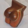 A chocolate sculpture of a woman 's boobs.